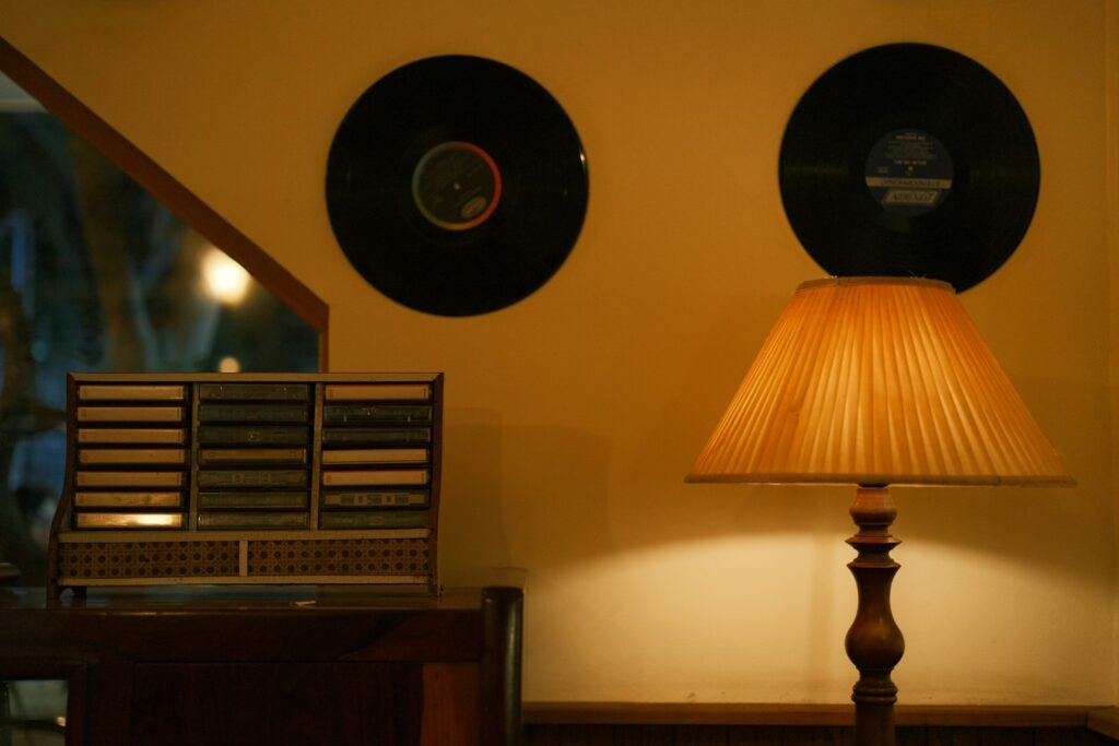 Records, lamp, and cassette player in cozy scene.
