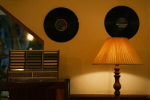 Records, lamp, and cassette player in cozy scene.