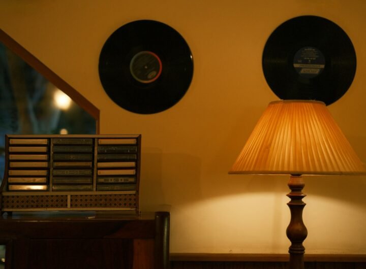 Records, lamp, and cassette player in cozy scene.