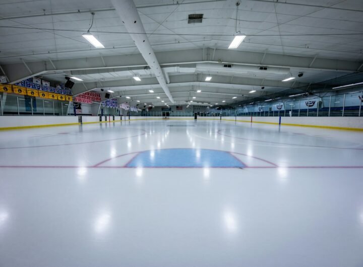 an indoor ice rink with a hockey goal