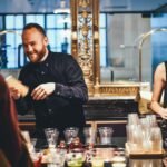 photo of man and woman mixing beverages