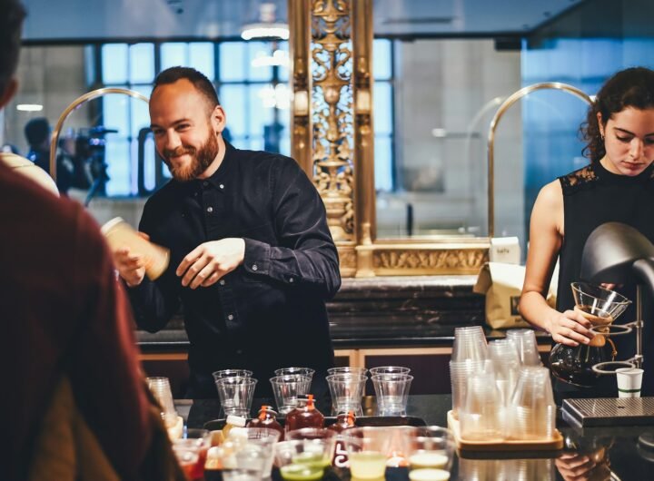 photo of man and woman mixing beverages