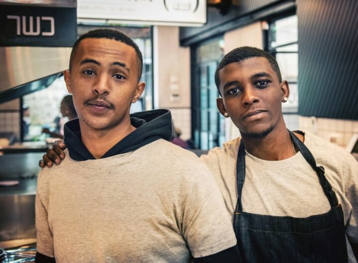 two men standing inside room