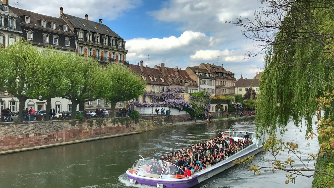 white and blue boat on river during daytime