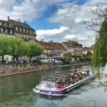 white and blue boat on river during daytime