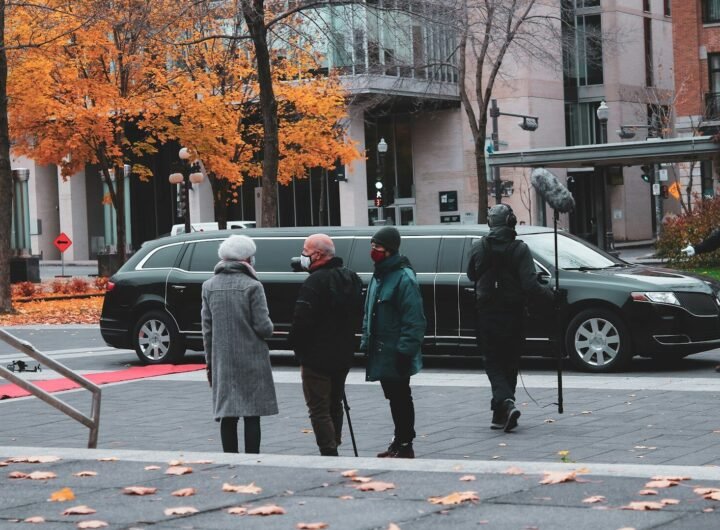 man in green coat walking on pedestrian lane during daytime
