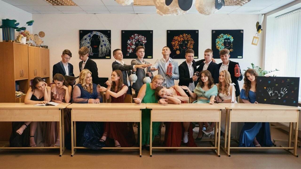 a group of people sitting at a long table